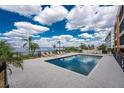 Enjoy the lovely community pool with lounge chairs and beautiful water views for relaxing and entertaining at 1601 Park Beach Cir # 114/4, Punta Gorda, FL 33950