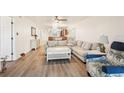 Bright living room featuring hardwood floors, a comfortable couch, and adjacent dining area at 175 Kings Hwy # 717, Punta Gorda, FL 33983