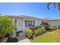 Inviting single-story home with well-maintained landscaping, lush greenery, and charming curb appeal at 196 The Corso # 196, Venice, FL 34285