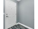 Condominium front door with gray wood look floors and gray paint at 2001 Bal Harbor Blvd # 2202, Punta Gorda, FL 33950