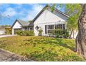Landscaped front yard of a cozy home featuring lush greenery and a well-manicured lawn at 2027 59Th N St, Clearwater, FL 33760