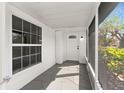 Covered front porch with decorative flooring and a view of the front door and window at 2027 59Th N St, Clearwater, FL 33760