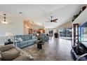 Spacious living room with tile floors, a vaulted ceiling with ceiling fan, and beautiful waterfront views at 2309 Via Veneto Dr, Punta Gorda, FL 33950