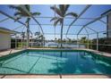 Screened in backyard pool with tropical views and a waterfront canal at 2309 Via Veneto Dr, Punta Gorda, FL 33950