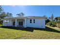 The backyard has sliding glass doors to get into the house with a covered porch at 23458 Macbeth Ct, Punta Gorda, FL 33980