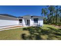 Well manicured front lawn and sidewalk leading up to the front door at 23458 Macbeth Ct, Punta Gorda, FL 33980