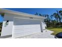 Garage door for two car garage. Address is shown above garage at 23458 Macbeth Ct, Punta Gorda, FL 33980