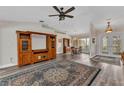 Open-concept living area showcasing hardwood floors, a vaulted ceiling, and views into the dining room at 23531 Dunstan Ave, Port Charlotte, FL 33954