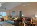 Open-concept living area featuring a sectional sofa, dining space, and plenty of natural light at 293 Broadmoor Ln, Rotonda West, FL 33947