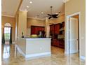 Open kitchen with wood cabinets, stainless appliances, granite counters and tile floor in this spacious home at 3812 Carupano Ct, Punta Gorda, FL 33950