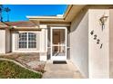 Home exterior featuring a screened entrance and manicured landscaping at 4221 Circleville St, North Port, FL 34286