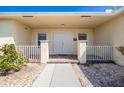Inviting front porch with double doors, brick accents, and decorative plants at 7014 Baylor Street, Englewood, FL 34224