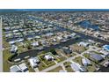 Aerial view showcasing the waterfront home's location on a canal within a community, perfect for boating enthusiasts at 721 Dania Ct, Punta Gorda, FL 33950