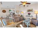 Comfortable living room with neutral tones, ceiling fan, and decor, flowing into the kitchen area at 721 Dania Ct, Punta Gorda, FL 33950