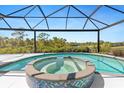Inviting covered pool and hot tub, offering a relaxing outdoor experience with beautiful views at 8774 Mystic Cir, North Port, FL 34287