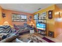 Cozy living room with tile flooring, plenty of seating, and a large window providing natural light at 1060 Venetian Pkwy, Venice, FL 34285