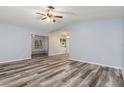 Open-concept living room with hardwood floors and a ceiling fan at 1341 Preston St, Port Charlotte, FL 33952