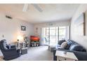Bright living room with comfortable seating and sliding glass door to balcony at 1515 Forrest Nelson Blvd # L204, Port Charlotte, FL 33952