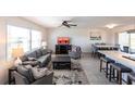 Open-concept living space with living room and dining area, featuring contemporary furnishings and tile flooring at 1516 Saint Clair Rd, Englewood, FL 34223