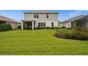 Expansive backyard with lush green lawn, screened porch and well-maintained landscaping at 16240 Palmetto St, Punta Gorda, FL 33982