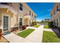 Well-maintained exterior with tidy landscaping, walkway leading towards a shared pool area, and a charming entrance at 17200 Acapulco Rd # 123, Punta Gorda, FL 33955