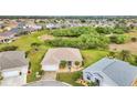 An aerial view showcases the home's landscaping and neighborhood with lush green surroundings at 1808 Kings Gate Ct, Punta Gorda, FL 33980