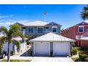 Charming two-story home featuring a white metal roof, double garage, and well-maintained landscaping at 2002 Bal Harbor Blvd # 1022, Punta Gorda, FL 33950