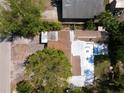 Aerial shot of the home's roof showing some damage and surrounding tropical foliage at 23077 Central Ave, Punta Gorda, FL 33980