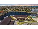 Aerial view of a multifamily building complex with a community pool, private docks, and waterway access at 240 Lewis Cir # 28, Punta Gorda, FL 33950