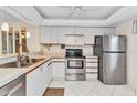 Well-lit kitchen featuring stainless steel appliances and white cabinets at 240 Lewis Cir # 28, Punta Gorda, FL 33950