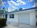 Attached single-car garage with an adjacent walkway that leads to the front door at 2715 Taylor Rd, Punta Gorda, FL 33950