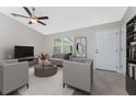 Bright and airy living room featuring modern furnishings, neutral decor, and a ceiling fan for added comfort at 481 Starborn St, Port Charlotte, FL 33954