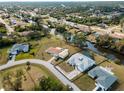 Stunning aerial view of a residential neighborhood with canal access and lush greenery at 908 Tropical Nw Cir, Port Charlotte, FL 33948