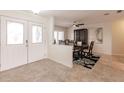 Inviting foyer flows into the dining area, showcasing tile floors and elegant double doors with decorative glass at 103 Colony Point Dr, Punta Gorda, FL 33950