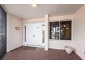 A welcoming condo entrance with double doors, brick floor and views of the lush landscaping at 11000 Placida Rd # 1501, Placida, FL 33946