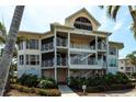 Exterior of home featuring multiple floors, screened in patios, and lush landscaping around the property at 11000 Placida Rd # 1501, Placida, FL 33946