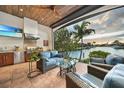 Enjoy the outdoor kitchen and seating area with a canal view, perfect for entertaining and relaxation at 1111 San Mateo Dr, Punta Gorda, FL 33950