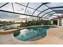 Relax in this screened-in pool and hot tub with views of the canal, blending luxury and outdoor living at 1111 San Mateo Dr, Punta Gorda, FL 33950