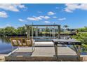 This outdoor dock with a covered boat lift provides easy access to waterfront fun and recreation at 131 Buckeye Nw Ave, Port Charlotte, FL 33952
