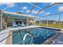 Enjoy this outdoor pool with a screened-in lanai, perfect for relaxation and entertainment at 131 Buckeye Nw Ave, Port Charlotte, FL 33952