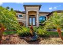 Beautifully landscaped front yard with lush tropical plants and a decorative alligator statue at 1341 Pine Siskin Dr, Punta Gorda, FL 33950