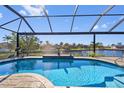 Stunning outdoor pool overlooking the water, perfect for relaxing and entertaining at 1341 Pine Siskin Dr, Punta Gorda, FL 33950