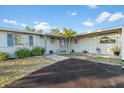 Charming single-story home featuring a well-manicured yard, nice landscaping, and a freshly paved driveway at 146 Francis Ne Dr, Port Charlotte, FL 33952