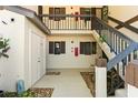 Exterior stairwell with open landing to unit doors, featuring simple landscaping at 19505 Quesada Ave # F103, Port Charlotte, FL 33948