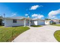 Charming home with a two-car garage, well-manicured lawn, and a spacious driveway at 21269 Edgewater Dr, Port Charlotte, FL 33952