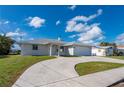 Charming home with a two-car garage, well-manicured lawn, and a spacious driveway at 21269 Edgewater Dr, Port Charlotte, FL 33952