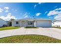 Charming home with a two-car garage, well-manicured lawn, and a spacious driveway at 21269 Edgewater Dr, Port Charlotte, FL 33952