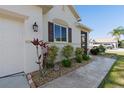 Charming single-story home with well-maintained landscaping, walkway and an attached two car garage at 25199 Chiclayo Ave, Punta Gorda, FL 33983