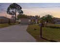 Charming single-story home with well-manicured lawn, mature trees, and a welcoming two car garage at 25199 Chiclayo Ave, Punta Gorda, FL 33983