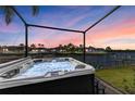 Outdoor hot tub overlooking a canal, offering a luxurious relaxation experience with a beautiful view at 333 Santander Ct, Punta Gorda, FL 33950